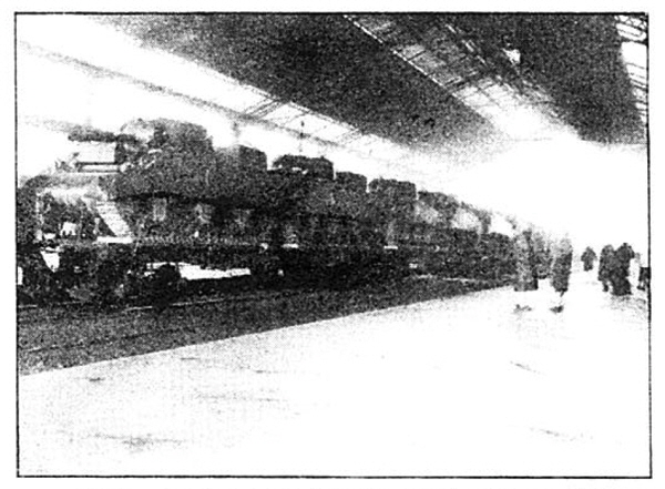 Photo Caption: Tanks move from ports to battle lines in USA car flats.