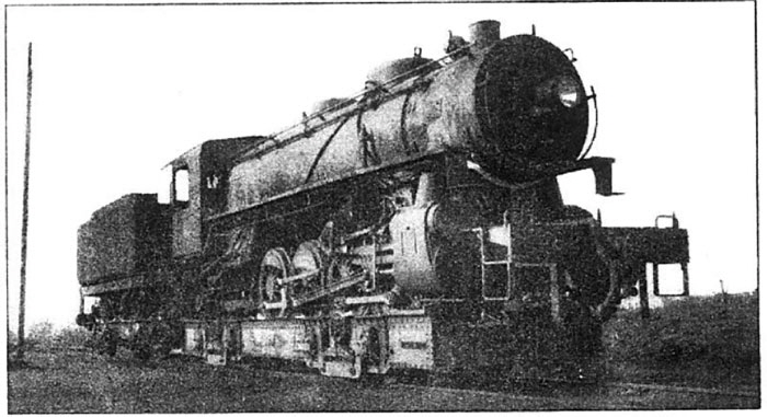 Photo Caption: Meter-gauge locomotive travels on well car